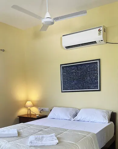 Air conditioner and ceiling fan in guest room for comfort in Auroville