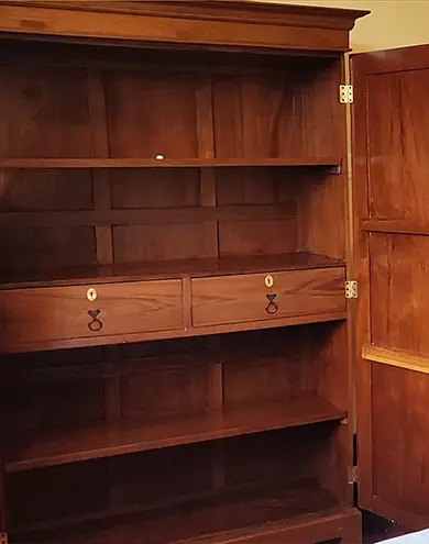 Large teak shelves and wardrobe in bedroom