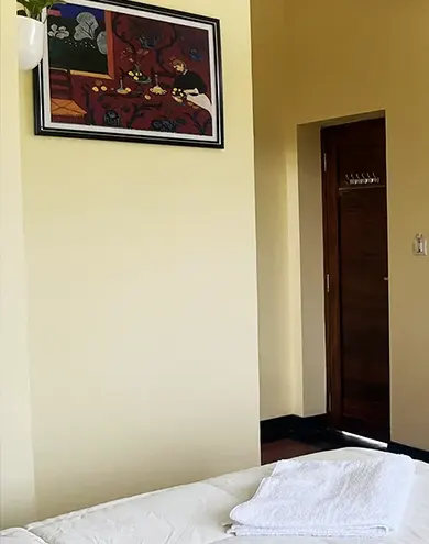 Comfortable guest room with large window and modern decor at Surya Villa